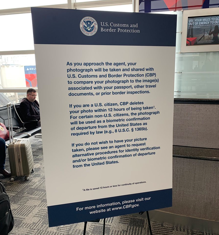 a notice in a U.S. airport indicating the facial scanning process and how to opt-out