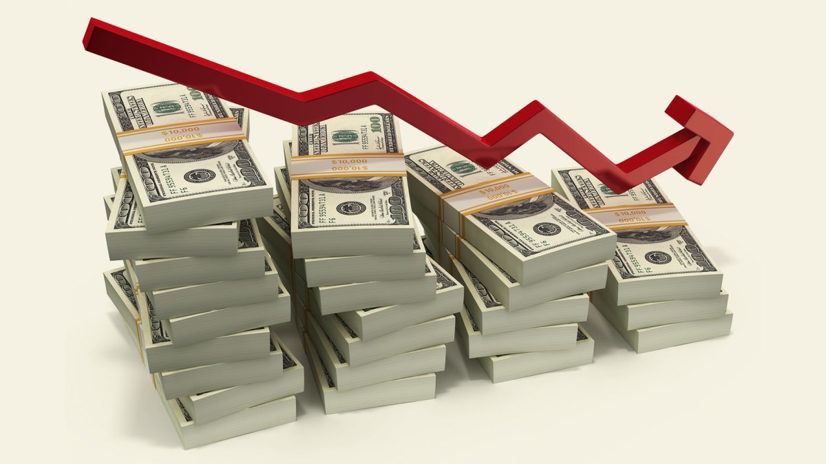 stacks of dollars with down red arrow