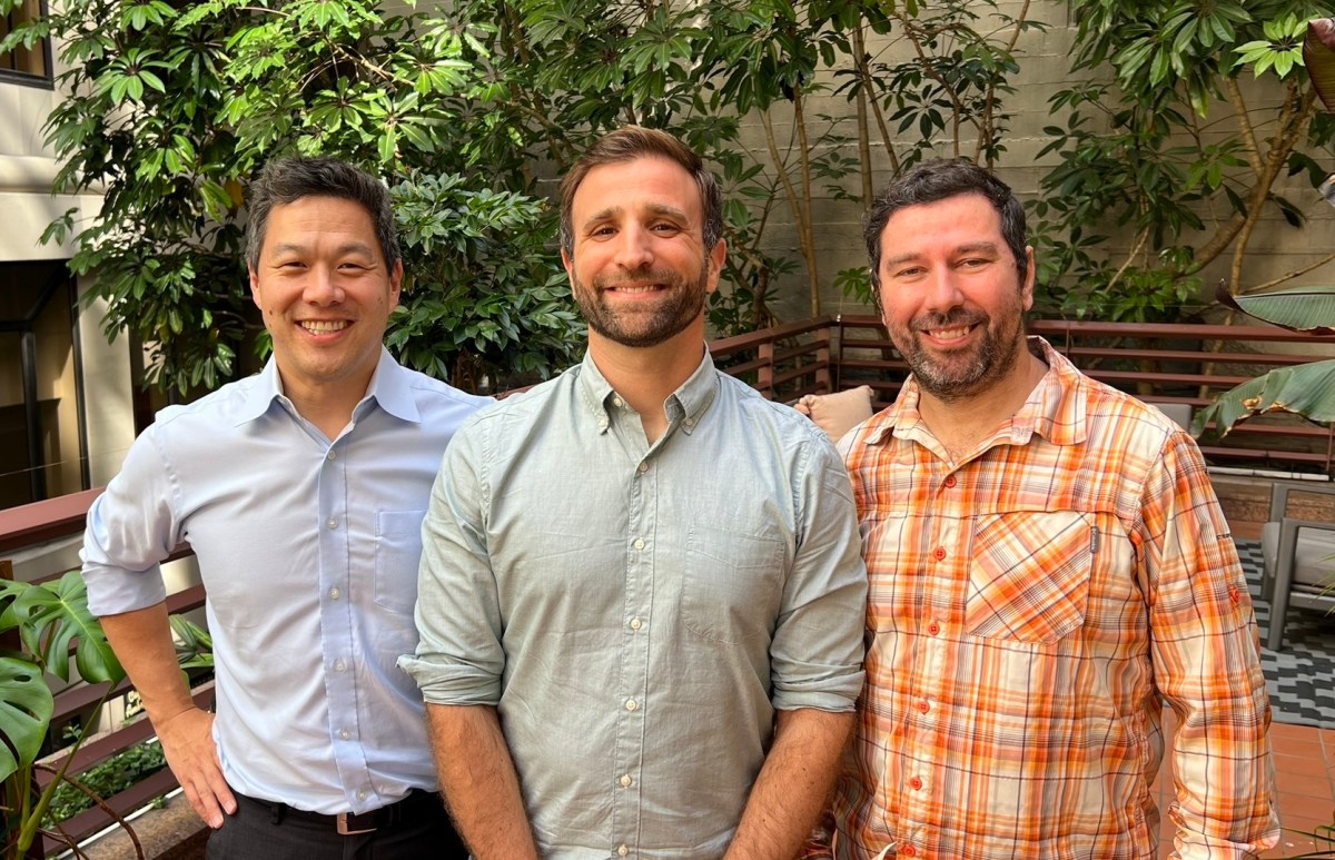 Cnaught founders stand before some trees.