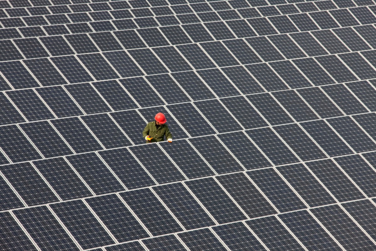 Man inspecting solar panels.