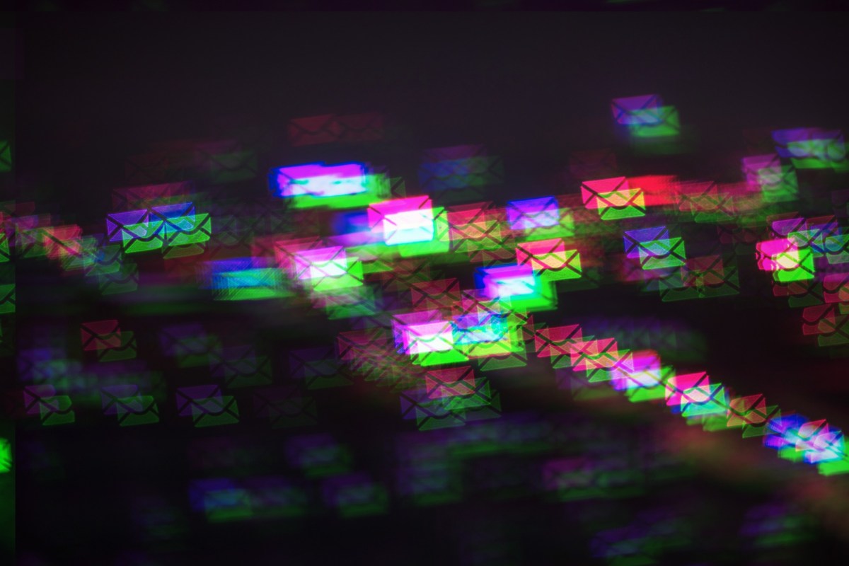 a pattern of multicolored photo-moshed envelopes flowing across on a dark background