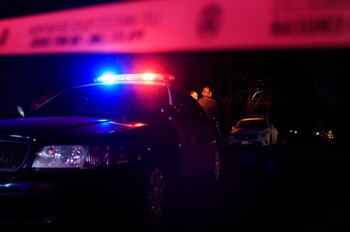 LAPD officers keep watch as the police investigate two people found dead in Rob Reiner