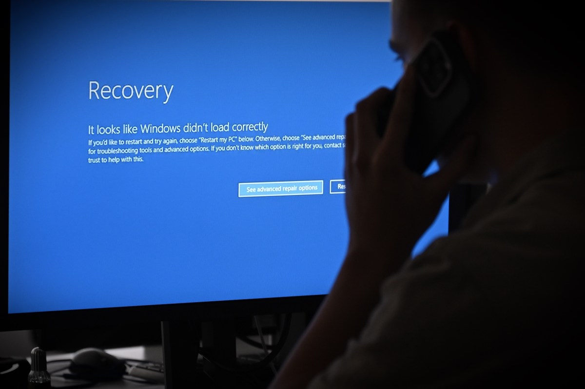In this photo illustration the blue screen of death errors on computer screens are viewed due to a global communications outage.