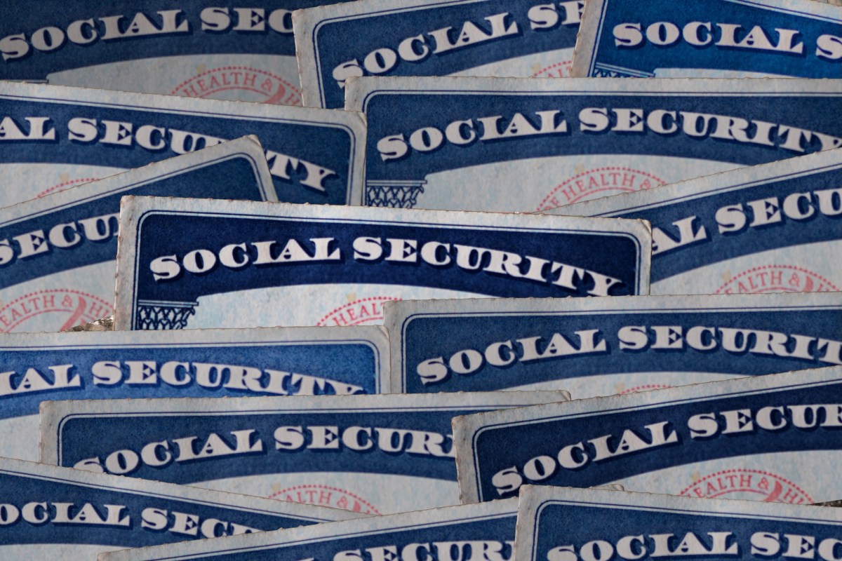 a selection of Social Security cards on a darkened background